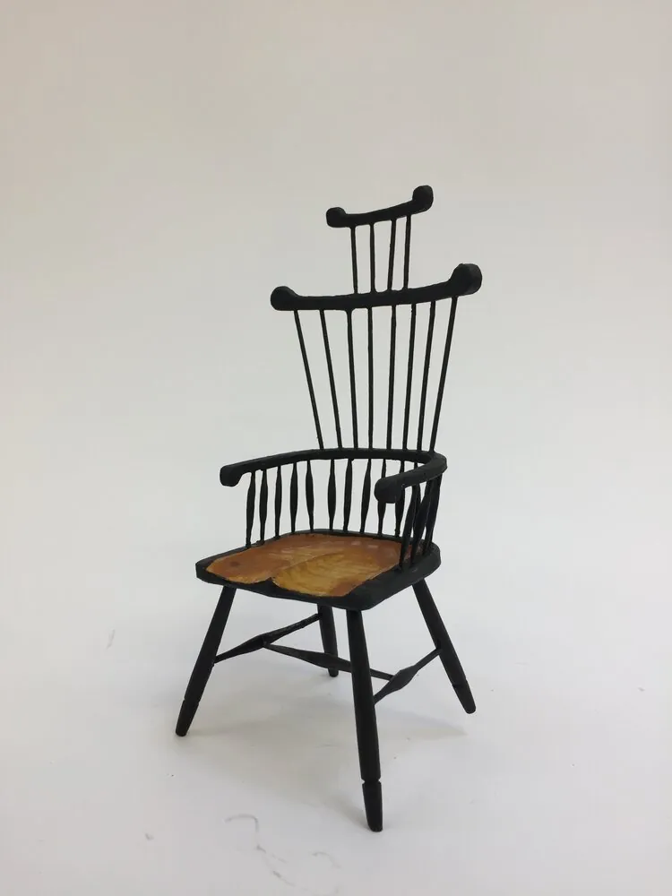 Full view of the miniature chair with tall spindle back
