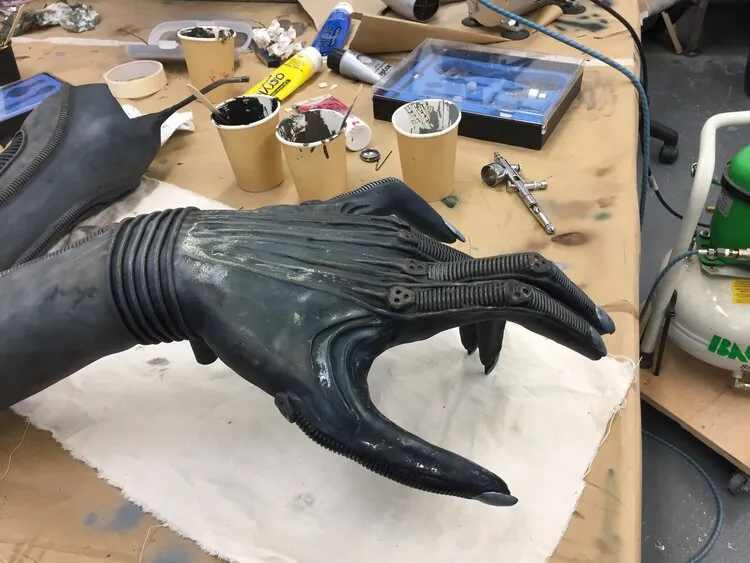 Close view of the clawed hand on the workbench