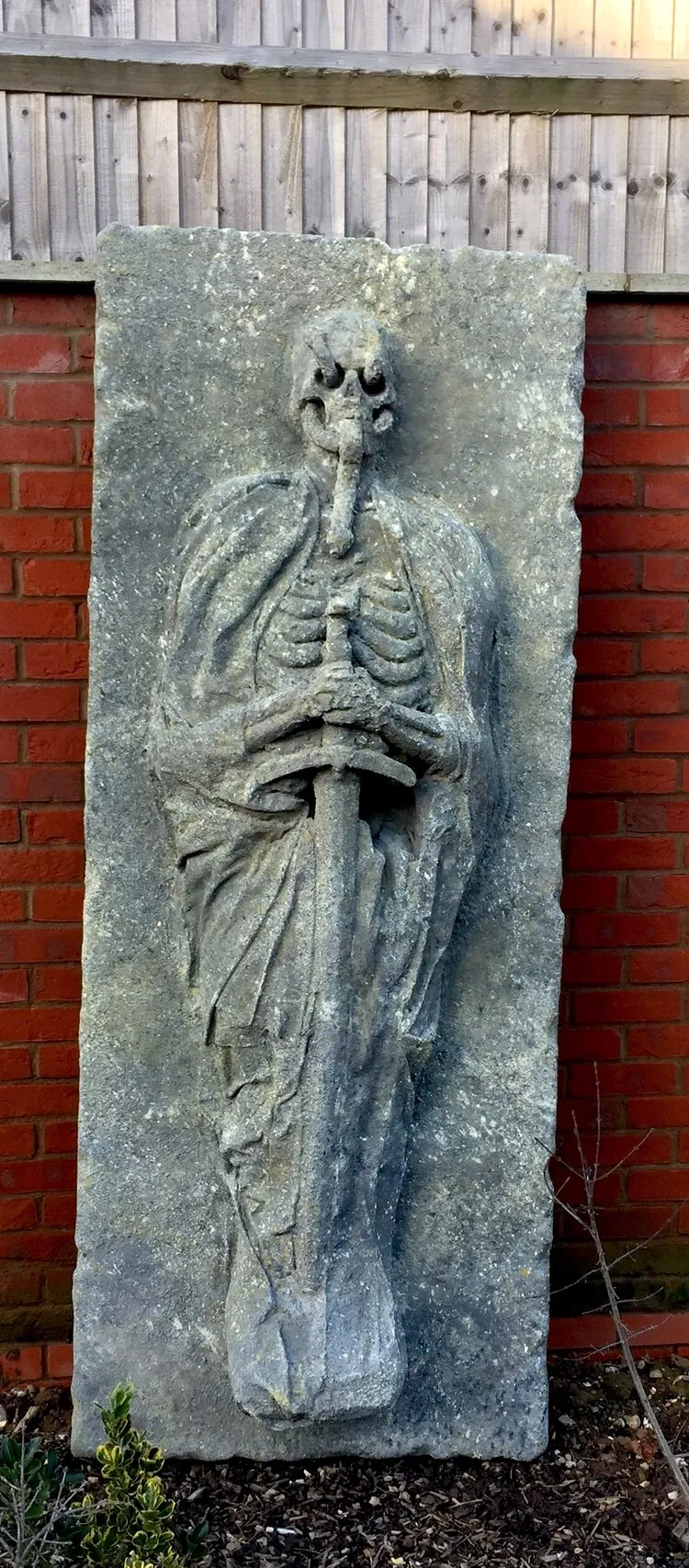 Top view of the tomb lid and skeleton relief