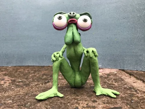 Green plasticine creature with oversized eyes