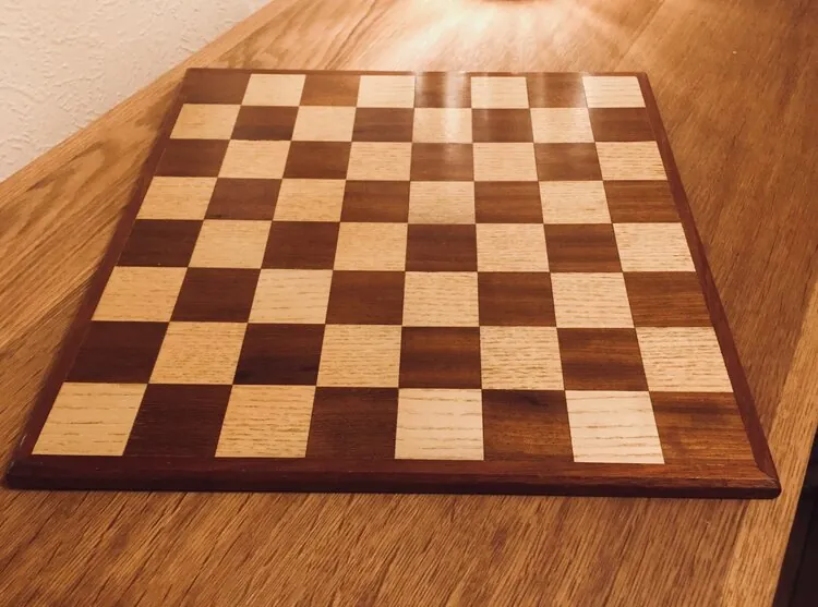 Wooden chessboard with alternating light and dark squares