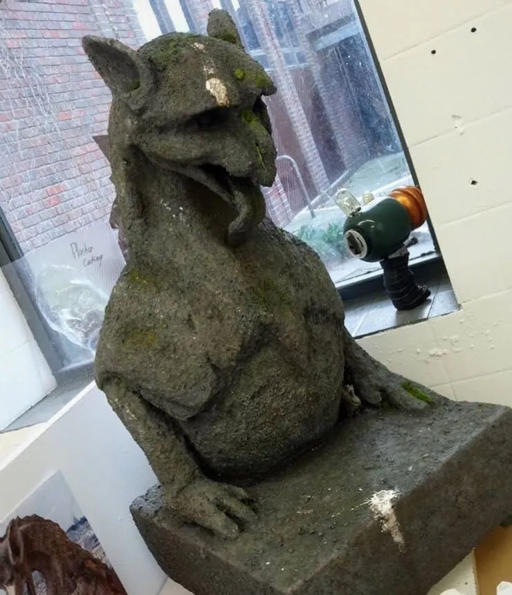 Small seated dragon-like creature sculpture