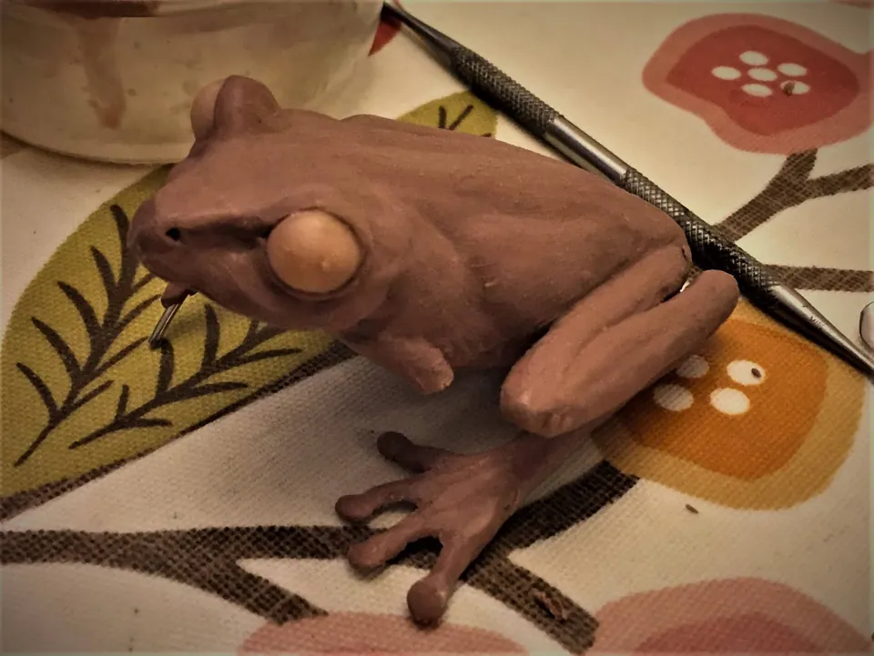 Clay frog sculpture with large eyes