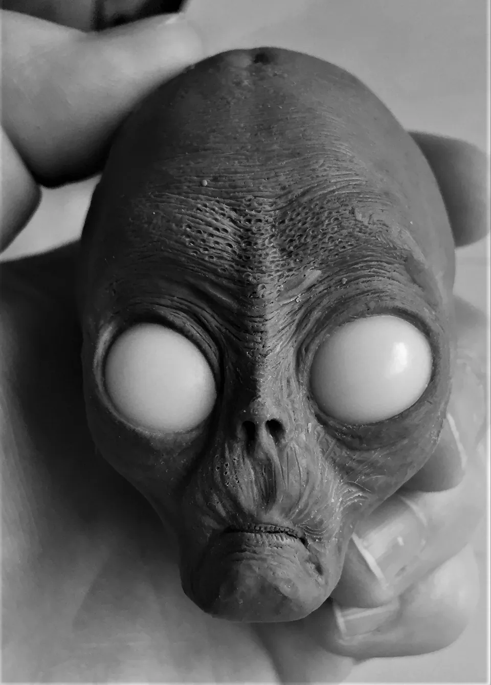 Sculpted grey alien head with large eyes