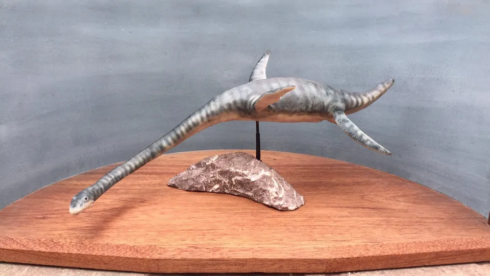 Full side profile of the puppet on its display stand