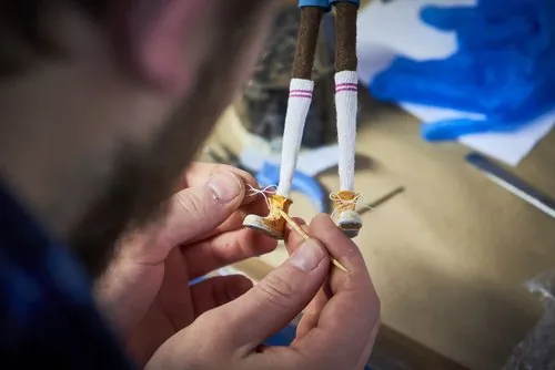 Painting the shoes and legs of a puppet
