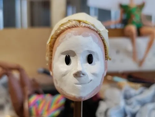 Unfinished puppet face with eye openings