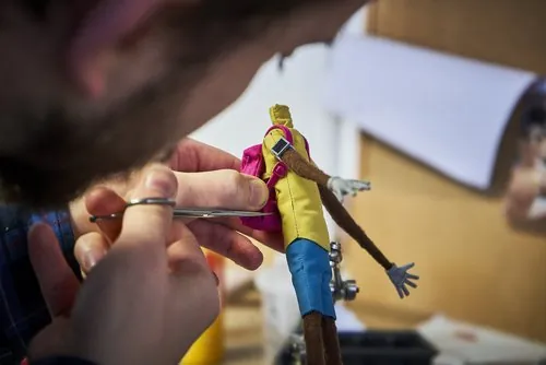 Painting a puppet character wearing a yellow shirt