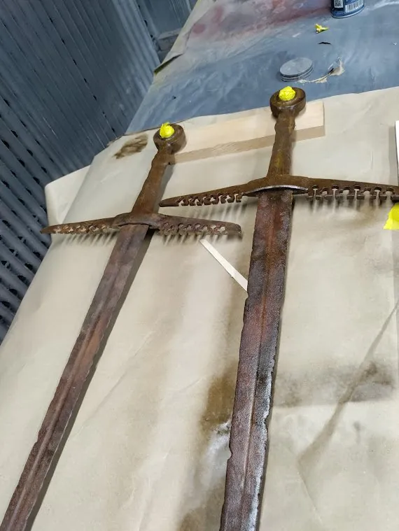 Finished sword props laid out side by side