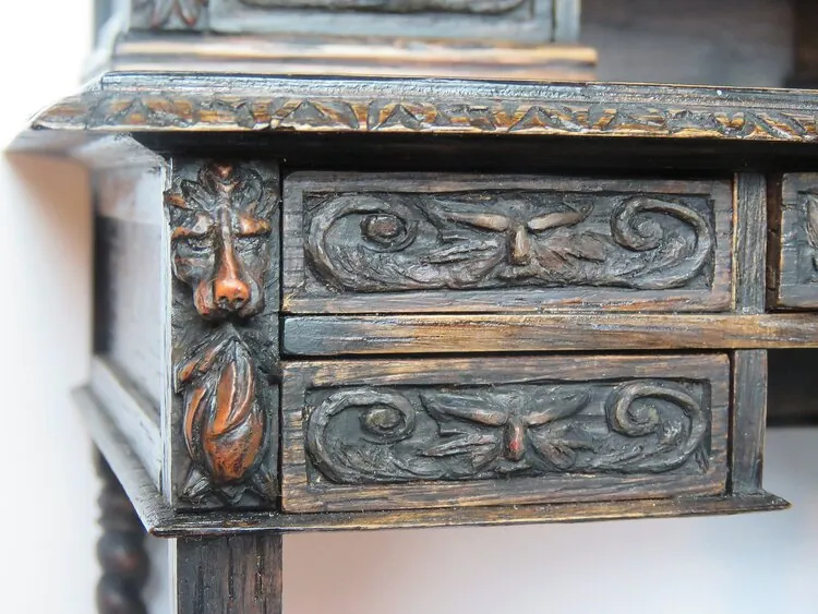 Close view of carved miniature drawer fronts