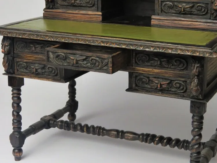 Open miniature drawer and carved desk apron