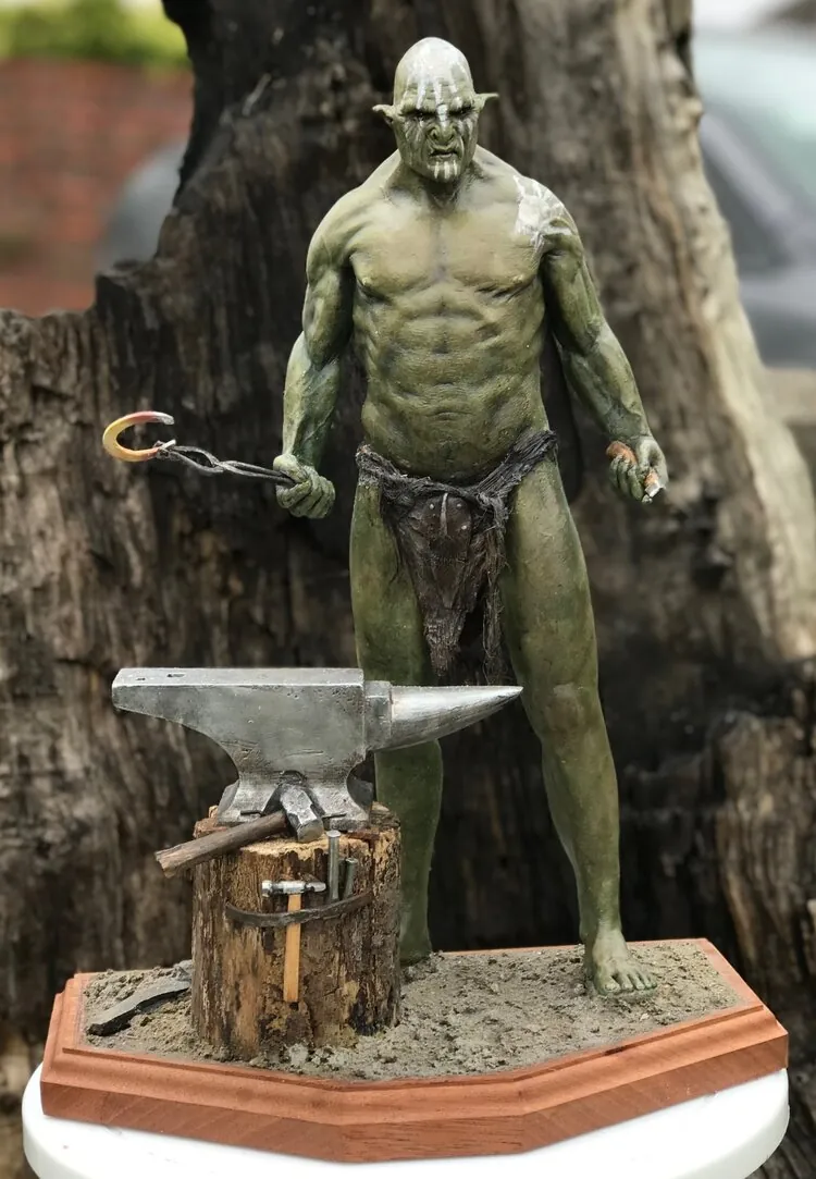 Uruk-Hai figure displayed beside a miniature anvil
