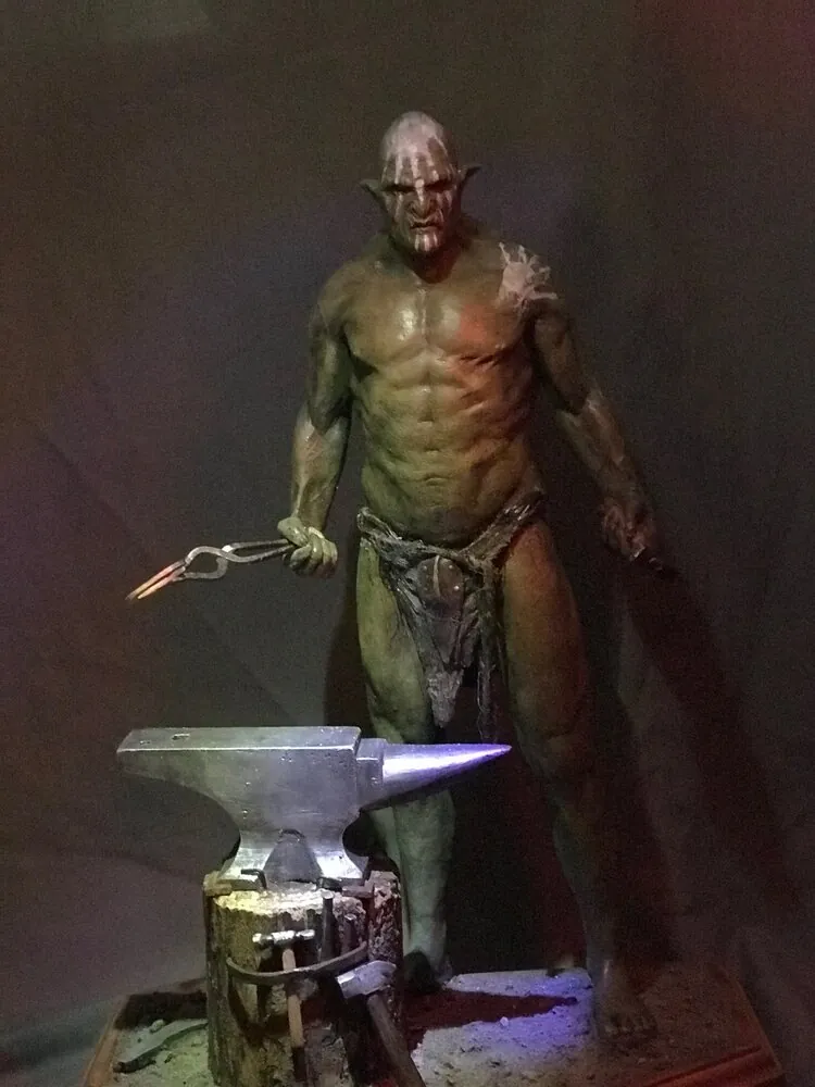 Painted Uruk-Hai figure with anvil under dramatic lighting