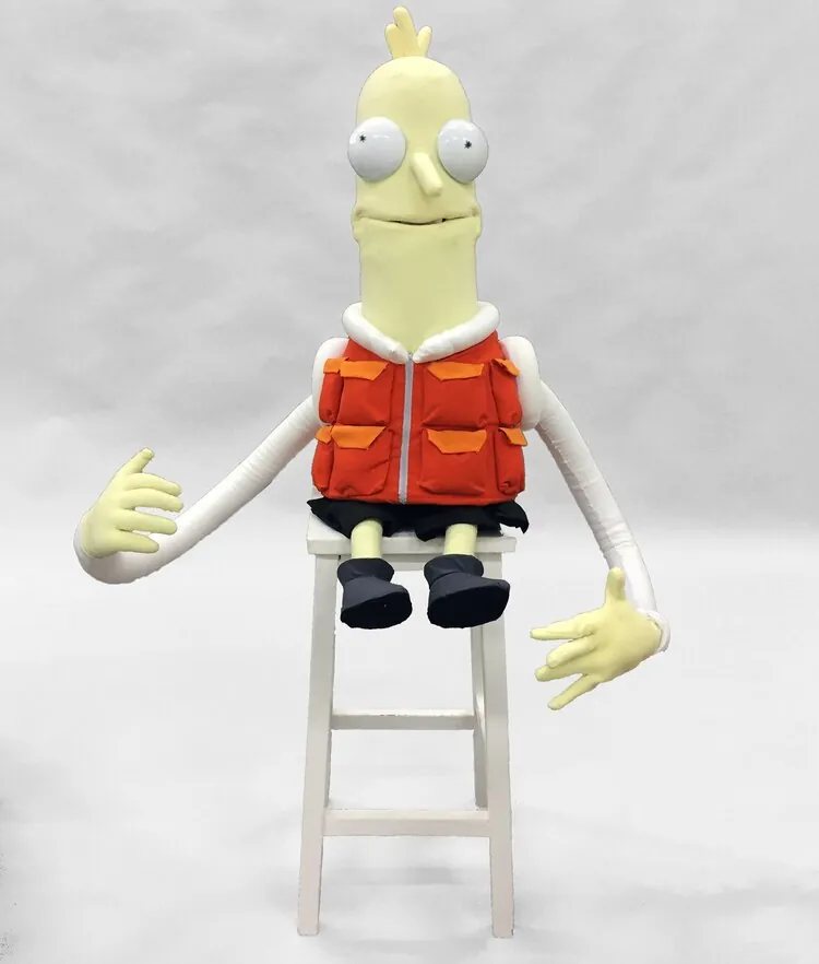 Finished Mr Stealy puppet seated on a stool